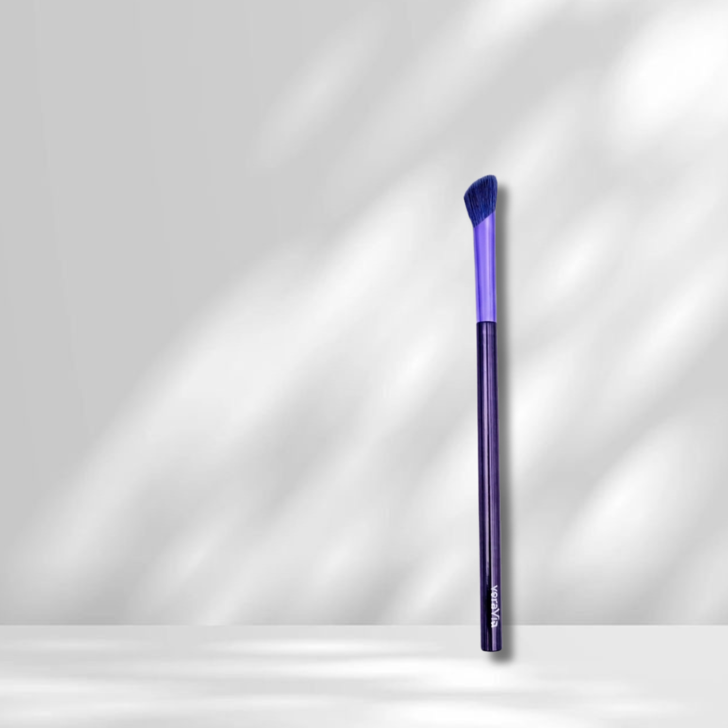 Purple makeup brush on a white background