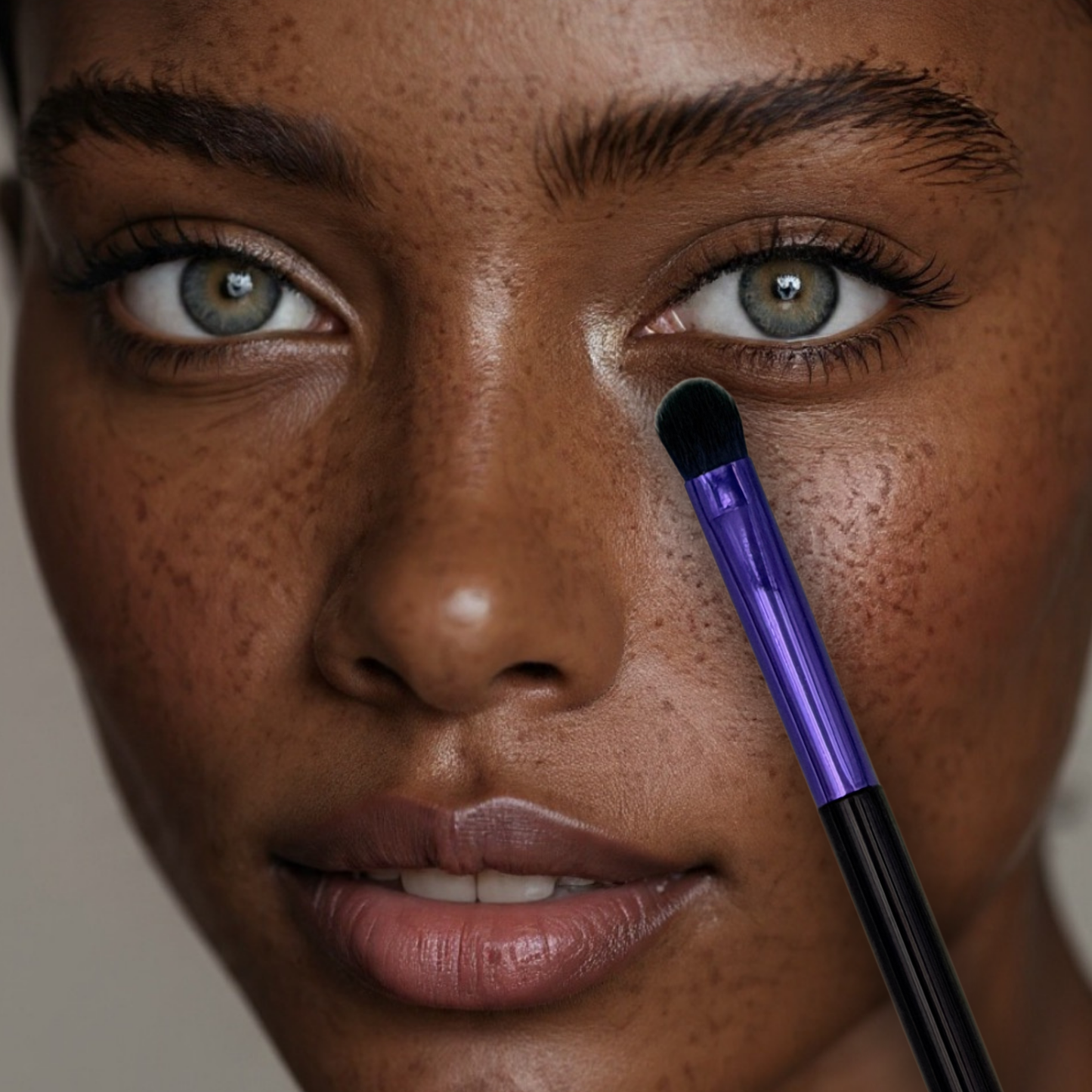 close up of professional model with green eyes using veraVia amethyst eyeshadow brush on inner corner