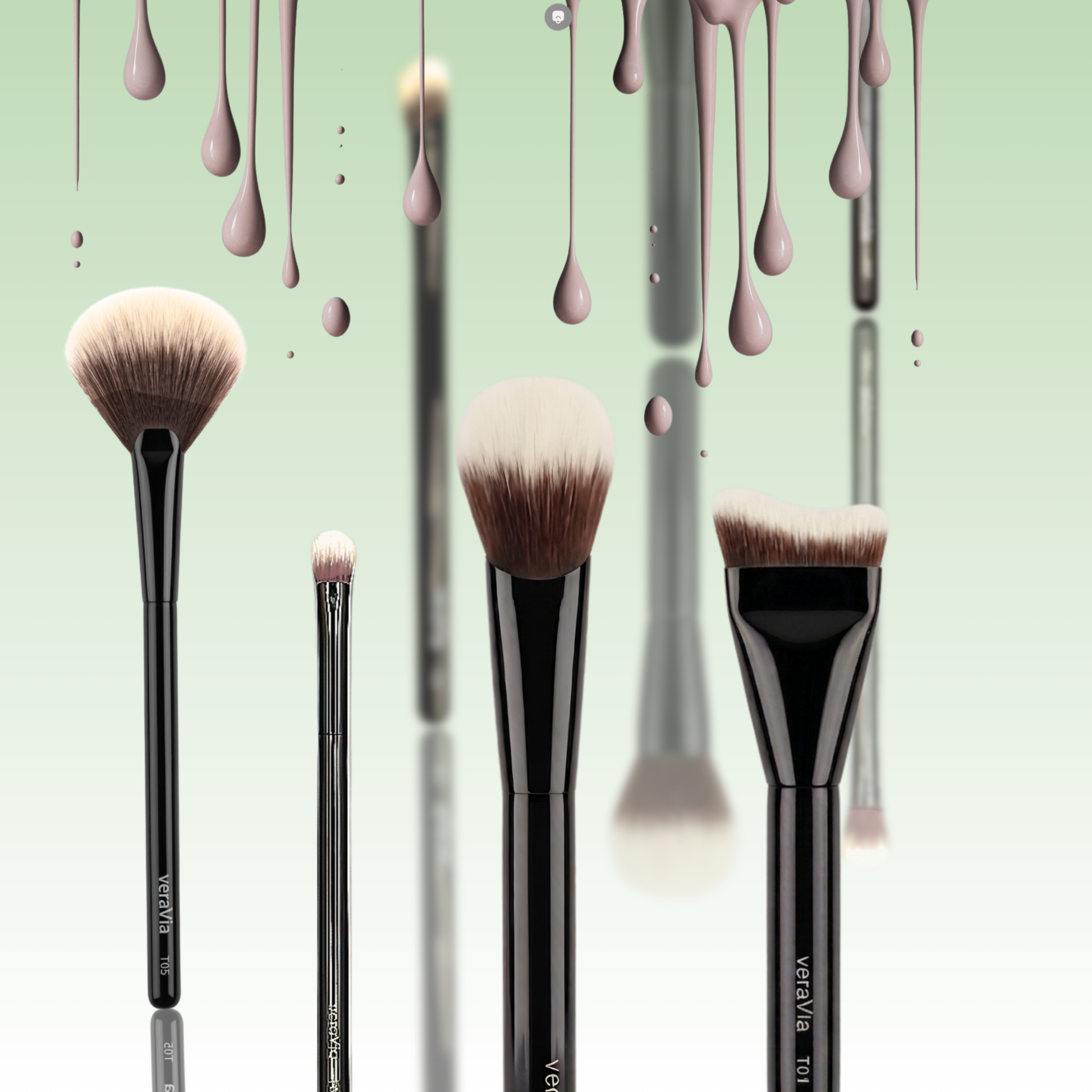 veraVia Naturlux makeup brushes styled under dripping liquid foundation drops against a fresh pastel green background