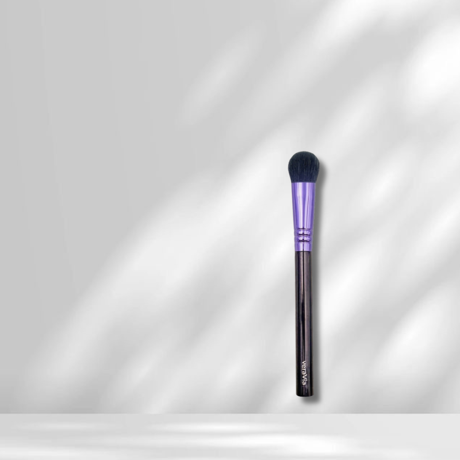 veraVia flat round concealer brush under elegant shadows aesthetic minimalist setting